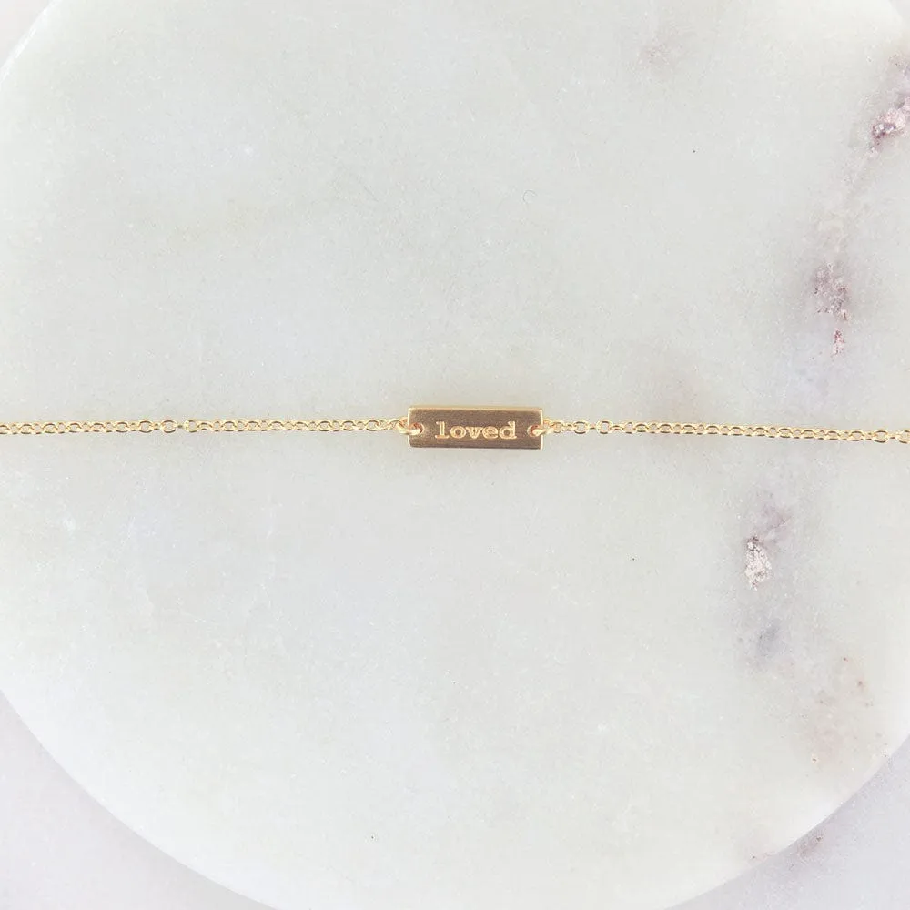 "LOVED" TINY PLATE BRACELET IN BRUSHED GOLD